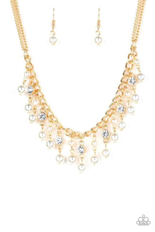 Paparazzi Accessories Regal Refinement - Gold Alternating with glassy white rhinestones, pearly white beaded tassels swing from the bottom of a shimmery gold chain below the collar for a refined flair. Features an adjustable clasp closure. Sold as one ind