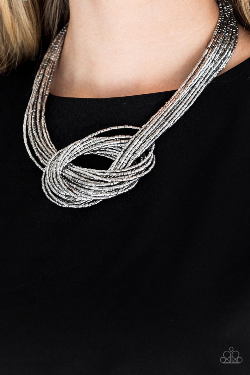 Paparazzi Accessories Knotted Knockout - Silver Countless strands of silver seed beads delicately knot together below the collar to create an unforgettable statement piece. Features an adjustable clasp closure. Jewelry