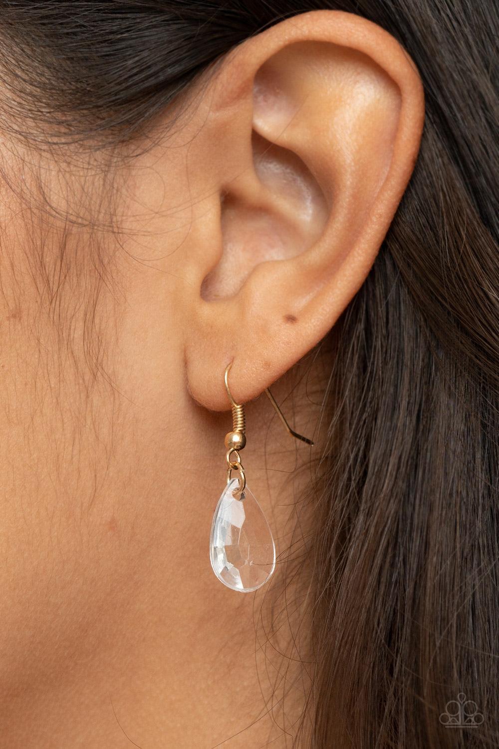 Paparazzi Accessories HEIR it Out - Gold Infused with cylindrical gold accents, a glittery collection of oversized glassy white teardrop gems slide along a dainty gold chain below the collar for a jaw-dropping finish. Features an adjustable clasp closure.