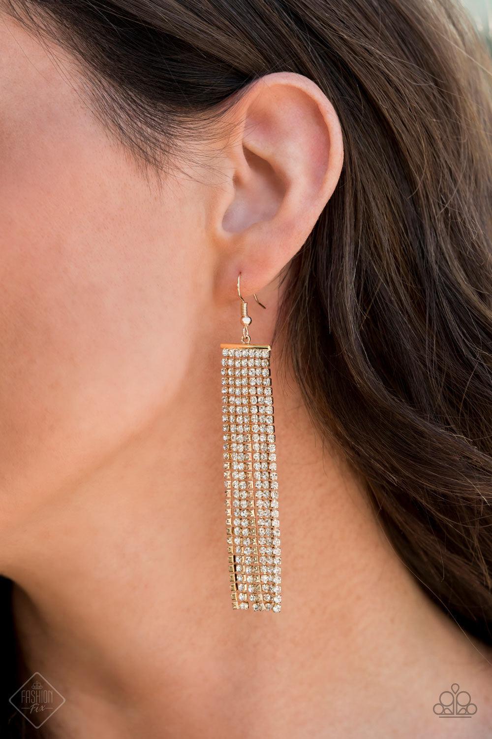 Paparazzi Accessories Top-Down Shimmer -Gold Strand after strand of glittery white rhinestones stream from a gold fitting, creating an elegant fringe that falls effortlessly from the ear. Earring attaches to a standard fishhook fitting. Jewelry