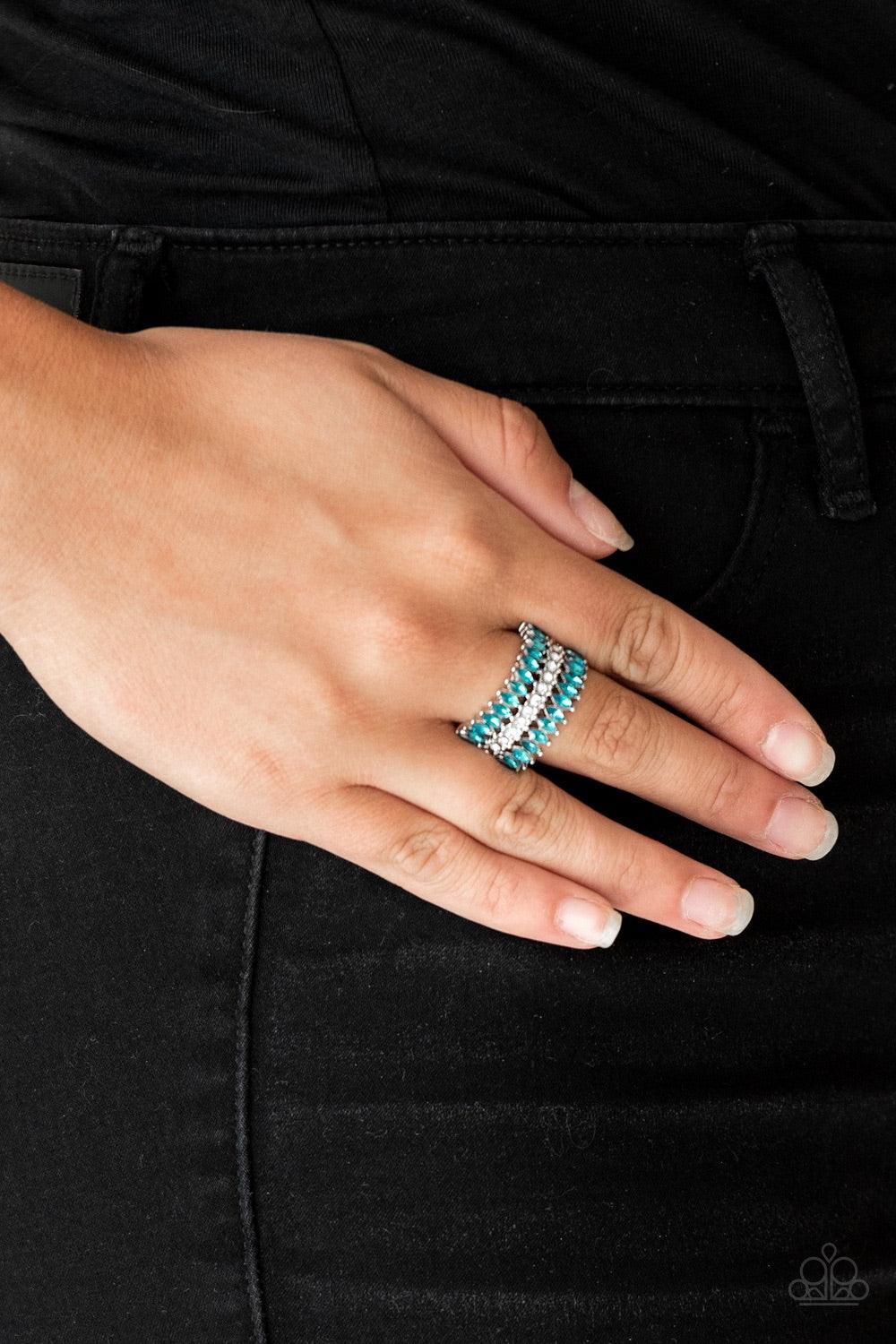 Paparazzi Accessories Treasury Fund - Blue Featuring refined marquise cuts, glittery blue rhinestones flare from a center of glassy white rhinestones, creating a regal band across the finger. Features a stretchy band for a flexible fit. Jewelry