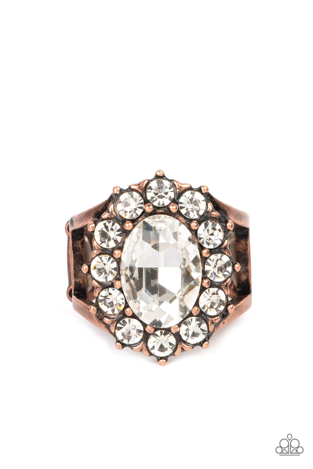 Paparazzi Accessories Moxie Magic A dauntless oval rhinestone is encircled by dainty sparkling gems. Accented with petite antiqued copper studs, the dramatic design joins with an airy layered copper band to create a captivating arrangement atop the finger