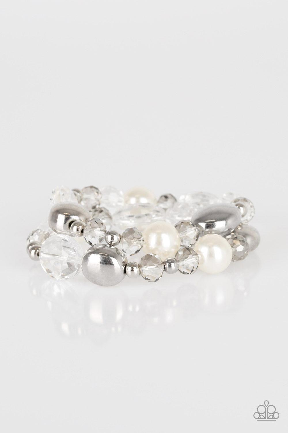 Paparazzi Accessories Downtown Dazzle - White An array of white pearls, shiny silver beads, and white crystal-like beads are threaded along stretchy bands around the wrist for a refined look. Jewelry