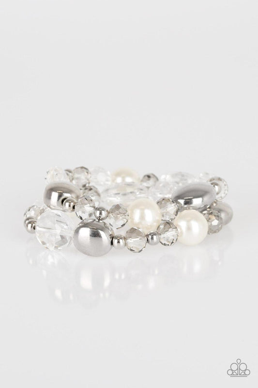 Paparazzi Accessories Downtown Dazzle - White An array of white pearls, shiny silver beads, and white crystal-like beads are threaded along stretchy bands around the wrist for a refined look. Jewelry