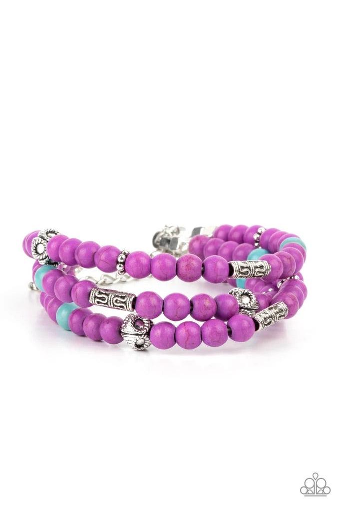 Paparazzi Accessories Desert Decorum - Purple A collection of purple and turquoise stone beads, silver cube beads, and ornate silver accents are threaded along invisible bands around the wrist, creating vivacious layers. Features an adjustable clasp closu