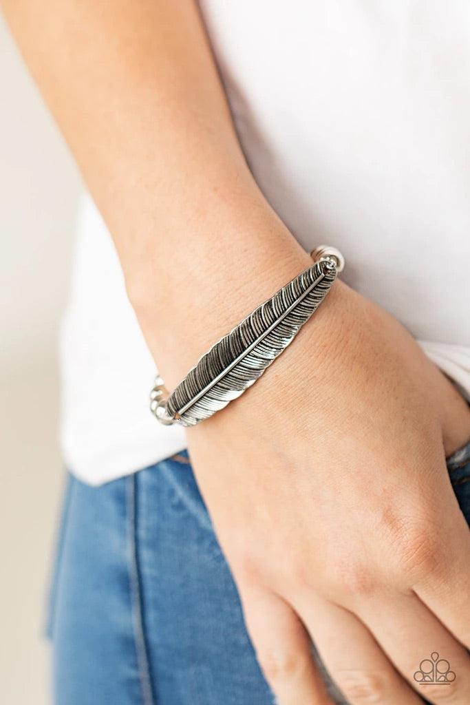 Paparazzi Accessories Featherlight Fashion - Silver Infused with a lifelike silver feather frame, a row of shiny silver beads are threaded along a stretchy band around the wrist for a seasonal fashion. Sold as one individual bracelet. Jewelry