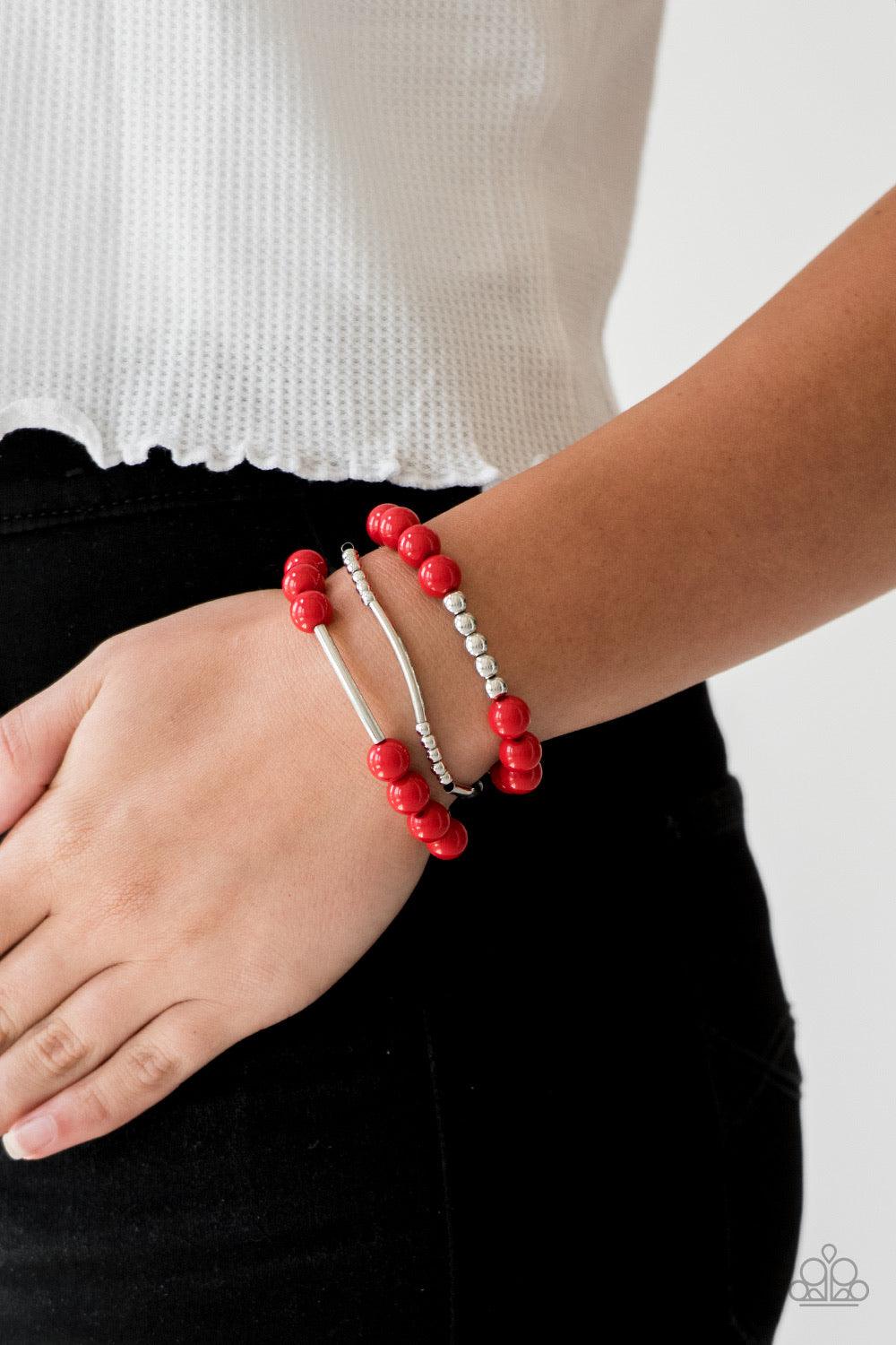 Paparazzi Accessories New Adventures - Red Polished red beads and mismatched silver beads are threaded along stretchy bands, creating colorful layers across the wrist. Jewelry