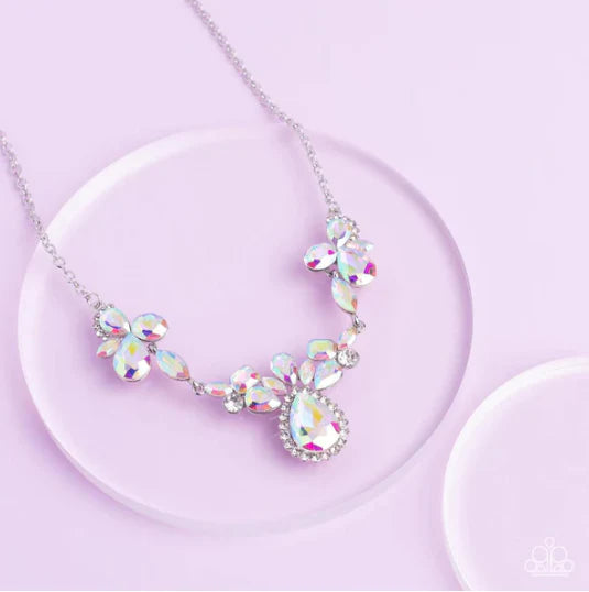 Paparazzi Accessories Intergalactic Icon - Multi Featuring emerald, oval, teardrop, and marquise style cuts, clusters of iridescent gems brilliantly sparkle below the collar for an out-of-this-world shimmer. Bordered in dainty white rhinestones, the cente