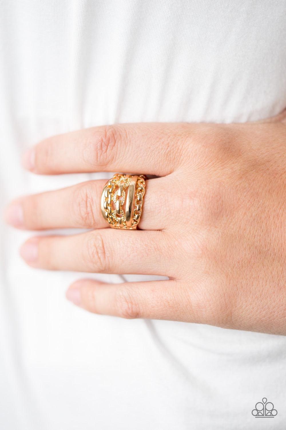 Paparazzi Accessories A CHIC Reaction - Gold A mishmash of gold chains and glistening gold bands stack across the finger, creating a chic collision of shimmery textures. Features a stretchy band for a flexible fit. Jewelry