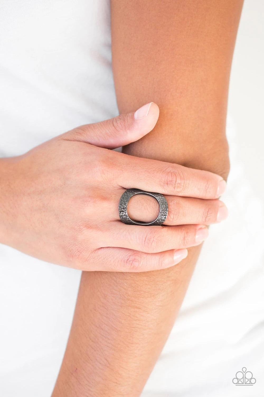 Paparazzi Accessories Tour De Contour - Black Delicately hammered in shimmery textures, a glistening gunmetal frame circles atop the finger for a modern look. Features a stretchy band for a flexible fit. Sold as one individual ring. Jewelry