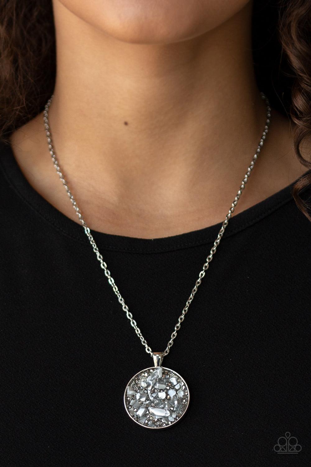 Paparazzi Accessories GLAM Crush Monday - Silver Infused with smoky and glassy rhinestone prisms, bits of metallic rock and dainty silver beads are sprinkled along the center of a round silver frame, creating a glittering pendant below the collar. Feature