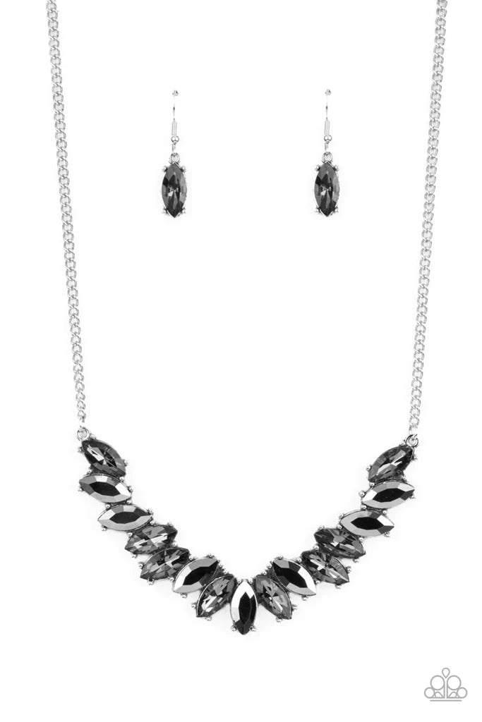 Paparazzi Accessories Galaxy Game-Changer - Silver Featuring pronged silver fittings, a sparkly series of smoky and hematite marquise cut rhinestones fan out below the collar for a stellar statement-making look. Features an adjustable clasp closure. Sold