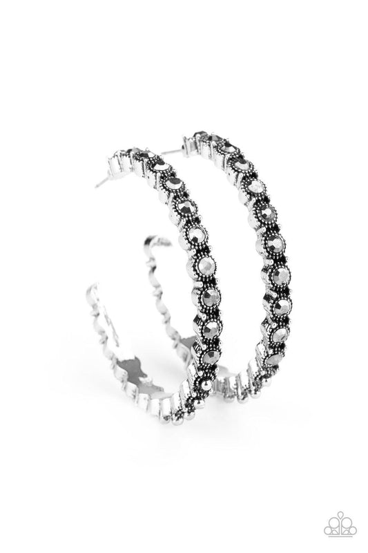 Paparazzi Accessories Rhinestone Studded Sass - Silver The front half of an ornately studded silver hoop is encrusted in smoky hematite rhinestones, adding a splash of exaggerated sparkle to the sassy display. Earring attaches to a standard post fitting.