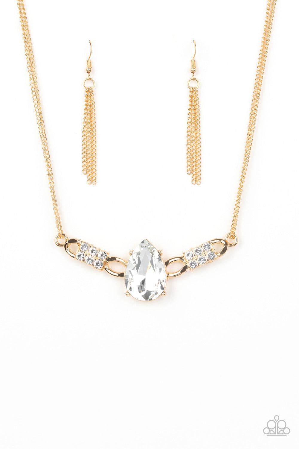 Paparazzi Accessories Way To Make An Entrance ~Gold Cut into an alluring teardrop, an oversized white rhinestone gem attaches to bold gold frames radiating with glassy white rhinestones. The dramatic pendant attaches to doubled gold chains, swinging horiz