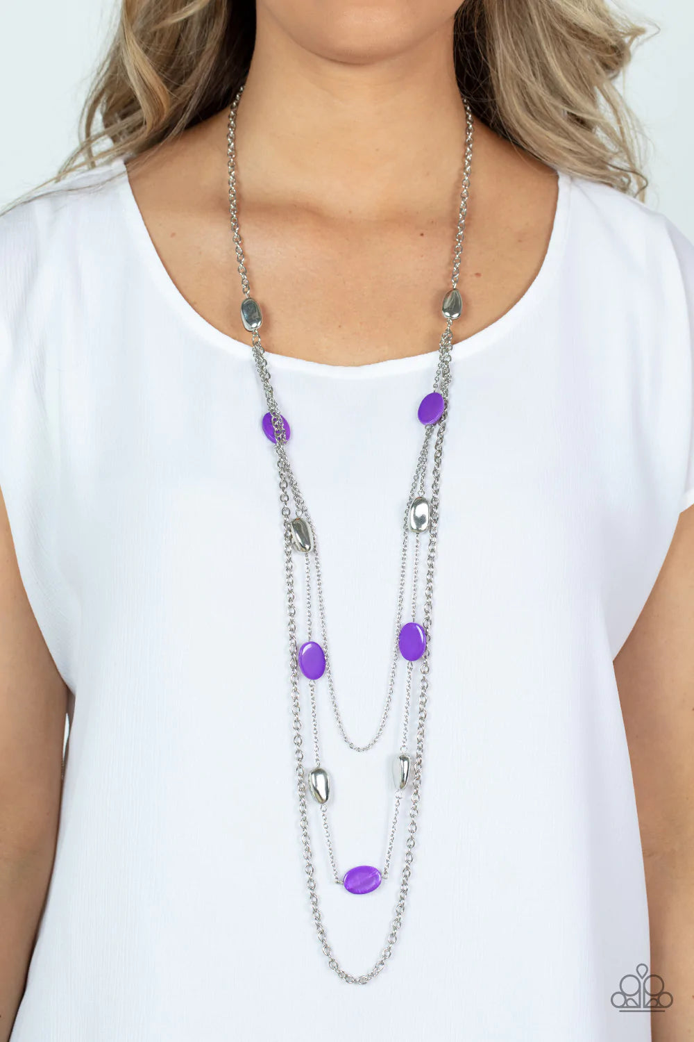 Paparazzi Accessories Barefoot and Beachbound - Purple A strand of silver pebble beads and purple shell-like discs layer with two mismatched silver chain across the chest, adding a seasonal pop of color to any outfit. Features an adjustable clasp closure.