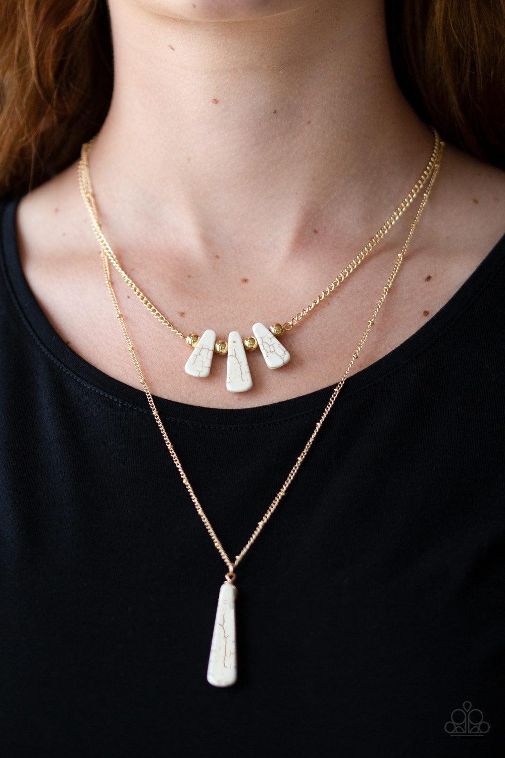 Paparazzi Accessories Basic Groundwork - White Chiseled into flared teardrop shapes, a dainty fringe of white stones and golden beads gives way to a large stone pendant, creating earthy layers down the chest. Features an adjustable clasp closure. Jewelry