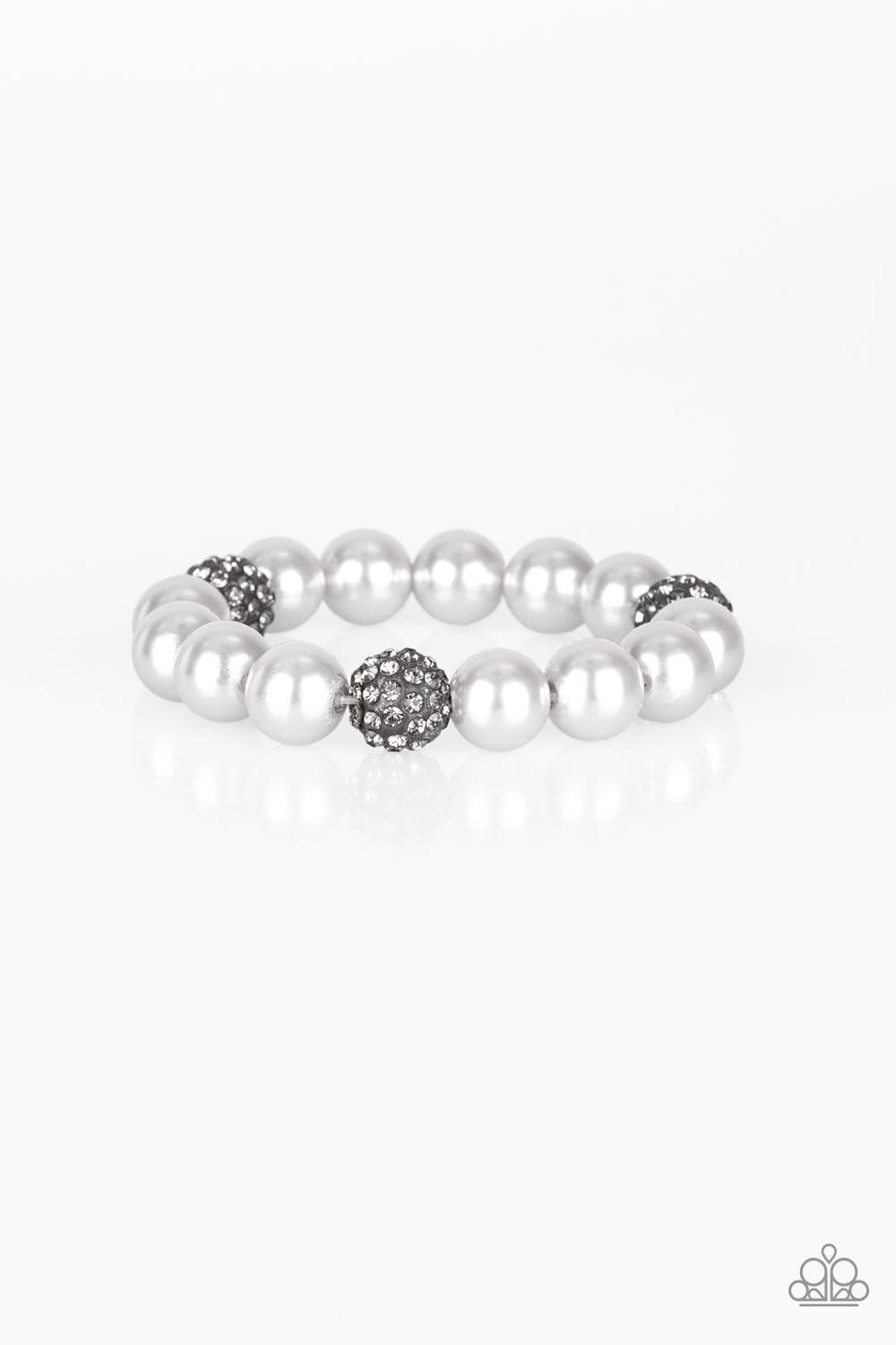 Paparazzi Accessories Cake Walk - Silver A collection of silver pearls and smoky rhinestone encrusted beads are threaded along a stretchy band around the wrist for a refined flair. Sold as one individual bracelet. Jewelry