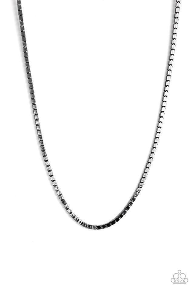 Paparazzi Accessories Boxed In - Black A thick strand of glistening gunmetal box chain drapes across the chest for a bold look. Features an adjustable clasp closure. Jewelry