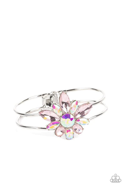 Paparazzi Accessories Chic Corsage - Pink Varying sizes of oval and marquise-cut gems in shades of light pink and shimmery iridescent bloom around a round-brilliant cut center in a similar iridescent hue. The dazzling collection of sparkly petals coalesce