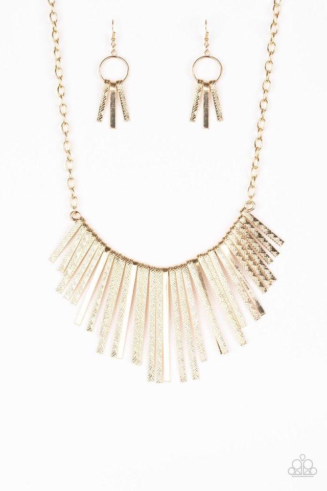 Paparazzi Accessories Welcome To The Pack - Gold Embossed in edgy linear patterns, flat gold rods alternate with plain gold rods below the collar, creating a fiercely tapered fringe. Features an adjustable clasp closure. Jewelry