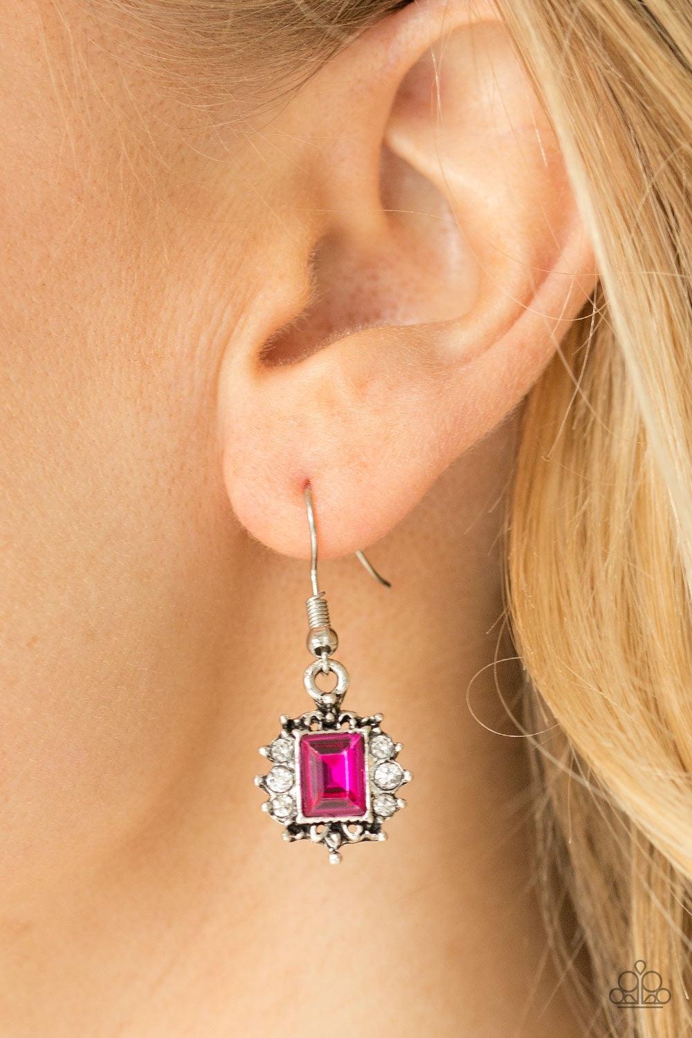 Paparazzi Accessories Can’t Stop The REIGN - Pink Featuring a regal emerald style cut, a glittery pink gem is pressed into a shimmery silver frame radiating with glassy white rhinestones for a refined look. Earring attaches to a standard fishhook fitting.