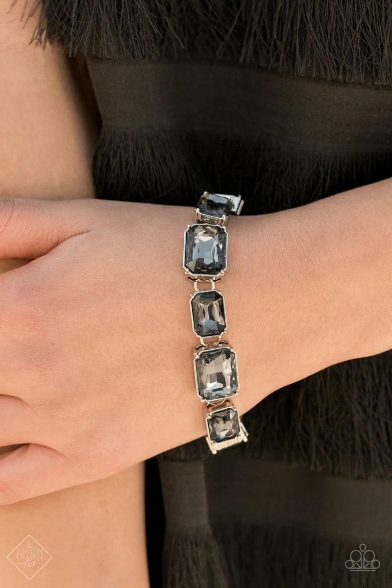 Paparazzi Accessories After Hours - Silver Encased in sleek silver fittings and varying in size, a regal chain of smoky emerald-cut gems wraps around the wrist for a timeless finish. Features an adjustable clasp closure. Sold as one individual bracelet. J