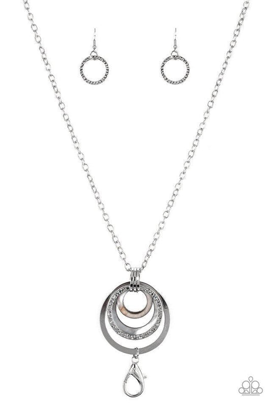 Paparazzi Accessories Coast Coasting - Silver Brushed in an iridescent finish, shell-like hoops join mismatched silver hoops at the bottom of an elongated silver chain for a whimsical look. A lobster clasp hangs from the bottom of the design to allow a na