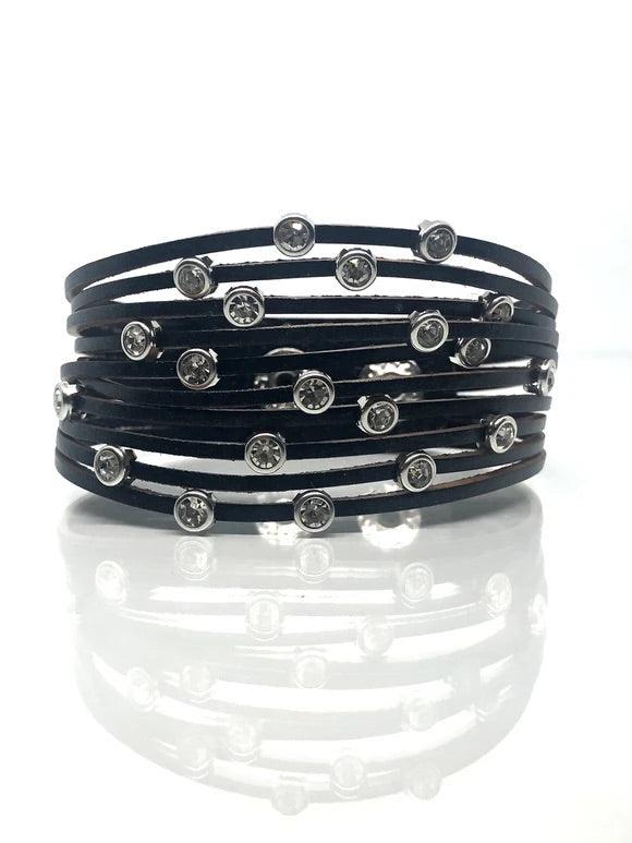 Paparazzi Accessories Meant to Beam - Black A black leather band has been spliced into skinny strands. Glittery white rhinestones are haphazardly sprinkled across the bands, scattering shimmer across the wrist. Features an adjustable snap closure. Sold as