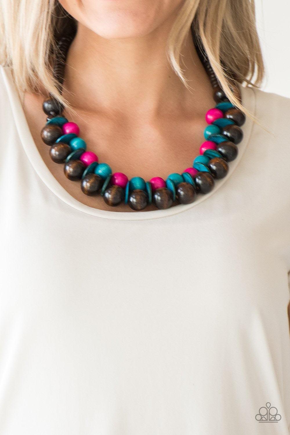 Paparazzi Accessories Caribbean Cover Girl - Multi Brushed in a distressed finish, vivacious pink and blue wooden beads and discs join below the collar for a summery look. Features a button loop closure. Jewelry