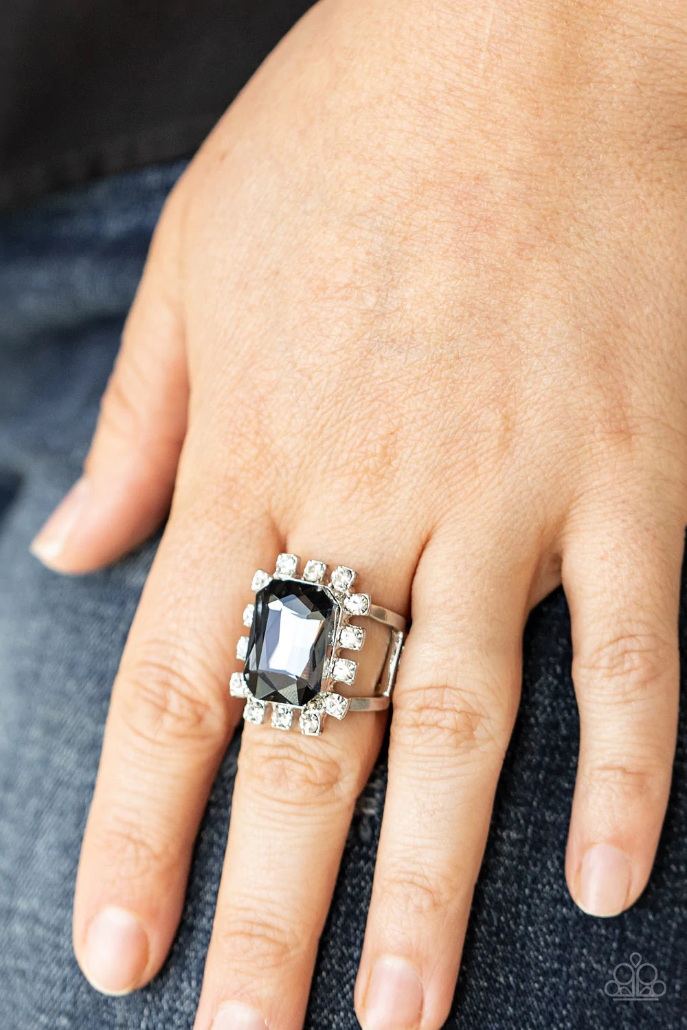 Paparazzi Accessories Galactic Glamour - Silver Featuring dainty silver square fittings, an explosion of glassy white rhinestones fans out from a dramatically oversized emerald cut smoky rhinestone center, creating a stellar centerpiece atop the finger. F