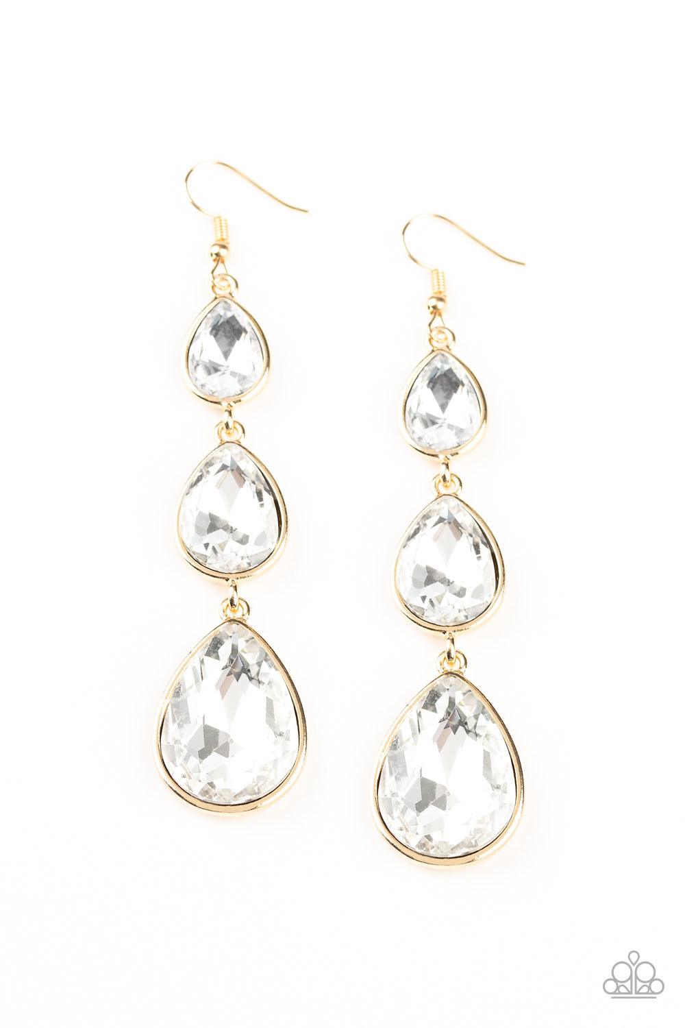 Paparazzi Accessories Metro Momentum - Gold Featuring sleek gold frames, exaggerated white teardrop rhinestones gradually increase in size as they drip from the ear. Earring attaches to a standard fishhook fitting. Sold as one pair of earrings. Jewelry