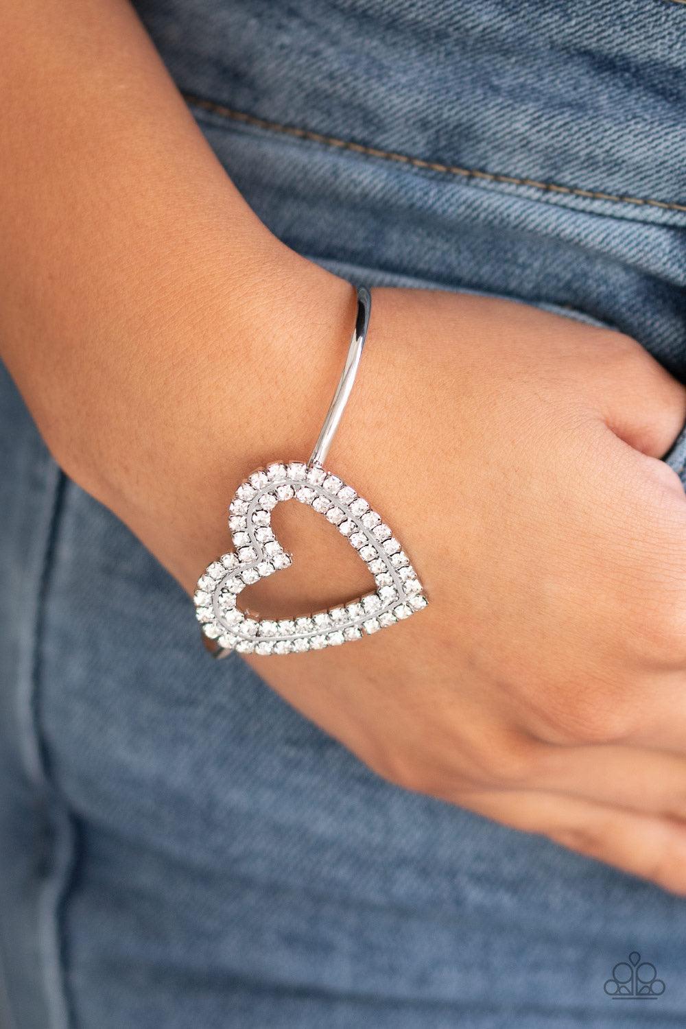 Paparazzi Accessories Heart Opener - White Two rows of glittery white rhinestones stack into a sparkling heart atop a dainty silver cuff for a charming look. Jewelry