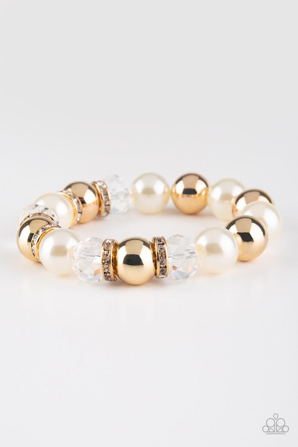 Paparazzi Accessories Camera Chic - White Oversized gold, crystal-like, and pearly white beads are threaded along a stretchy elastic band and wrapped around the wrist for a glamorous look. White rhinestone encrusted rings are sprinkled between the dramati