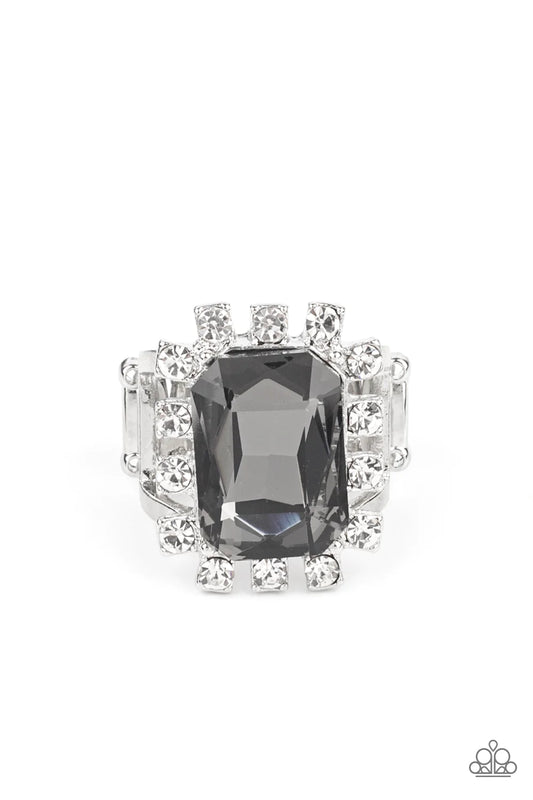 Paparazzi Accessories Galactic Glamour - Silver Featuring dainty silver square fittings, an explosion of glassy white rhinestones fans out from a dramatically oversized emerald cut smoky rhinestone center, creating a stellar centerpiece atop the finger. F