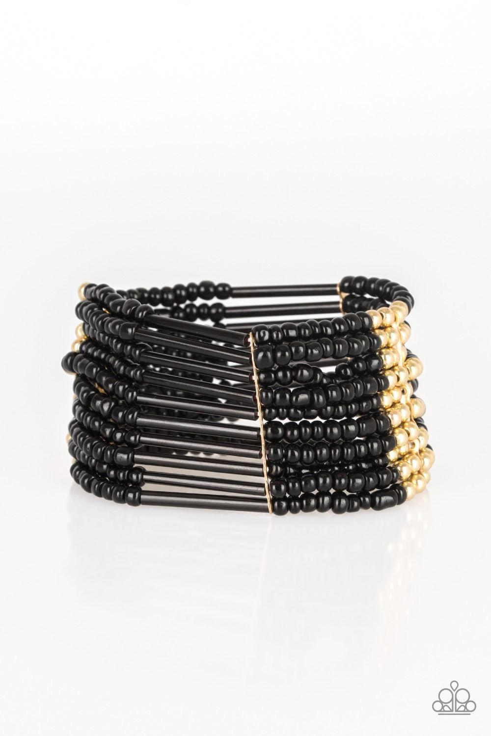 Paparazzi Accessories Rural Retreat - Gold Joined together with metallic fittings, black seed beads are threaded along stretchy elastic bands. Sections of gold beads are sprinkled along the edgy layers, adding hints of shimmer to the seasonal palette. Jew