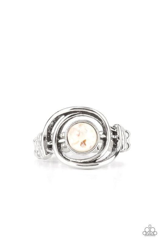 Paparazzi Accessories Celestial Karma - White Glistening silver bars swirl around a glassy white bead flecked in iridescent shell, creating an ethereal centerpiece atop the finger. Features a dainty stretchy band atop the finger. Sold as one individual ri