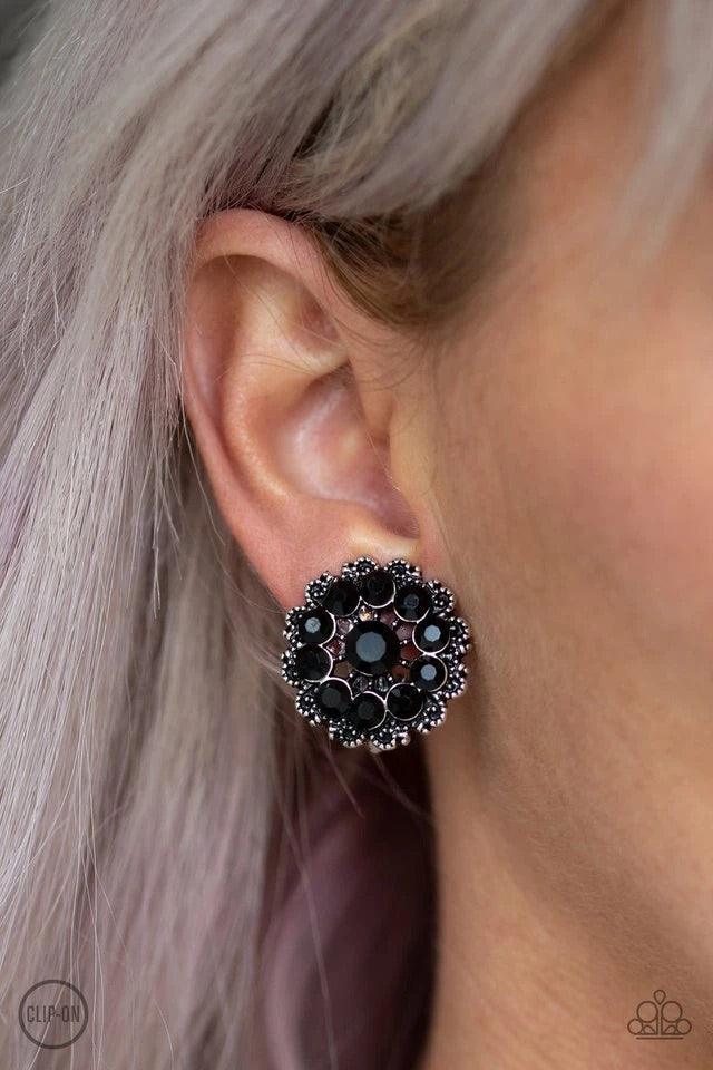 Paparazzi Accessories Business Bedazzle - Black *Clip-On Dotted silver filigree spins around a black rhinestone encrusted center, swirling into a refined floral frame. Earring attaches to a standard clip-on fitting. Sold as one pair of clip-on earrings. J