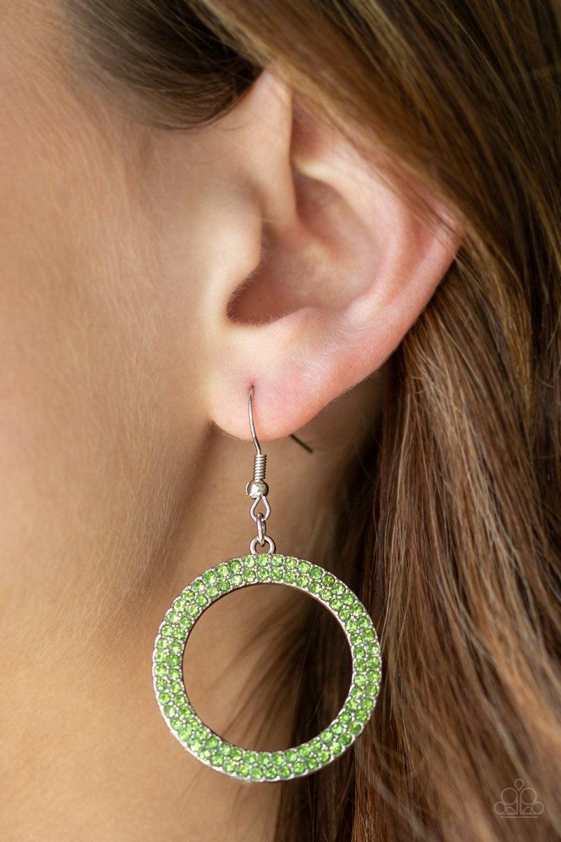 Paparazzi Accessories Bubbly Babe - Green Two rows of glittery green rhinestones are encrusted along a shimmery silver circle, creating a bubbly frame. Earring attaches to a standard fishhook fitting. Sold as one pair of earrings. Jewelry