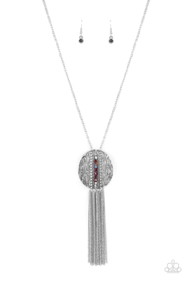 Paparazzi Accessories Radical Refinery - Red An oversized concave silver disc, ribbed with linear texture, creates a dramatic backdrop for a vertical row of faceted red beads. A flirty tassel of delicate silver chains sways from the bottom of the pendant