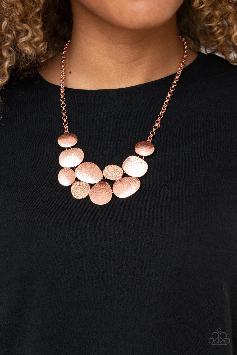 Paparazzi Accessories A Hard LUXE Story - Copper Featuring imperfect oval shapes, a series of delicately scratched and peach rhinestone encrusted shiny copper frames connect into a clustered pendant below the collar for a refined flair. Features an adjust