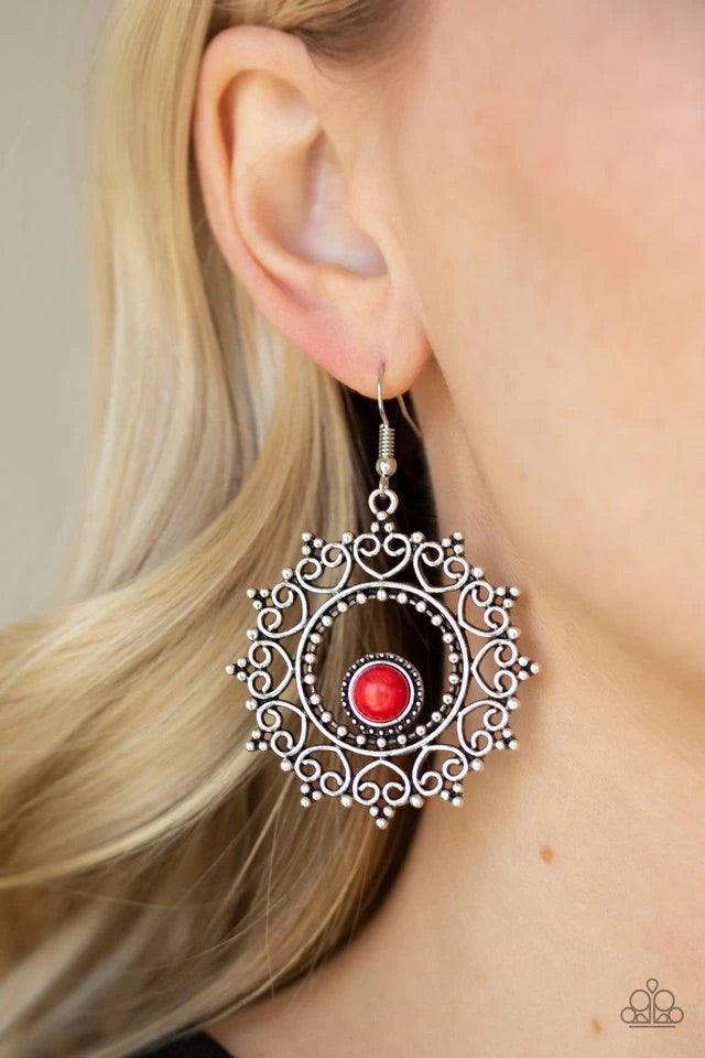 Paparazzi Accessories Wreathed In Whimsically - Red Featuring studded details, frilly heart-shaped filigree spins around a smooth red stone bead, creating a whimsical wreath. Earring attaches to a standard fishhook fitting. Sold as one pair of earrings. J