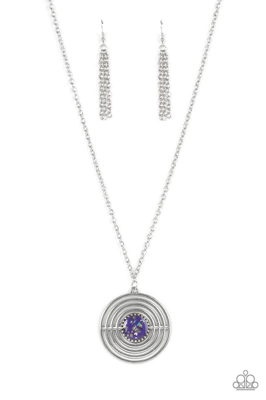 Paparazzi Accessories Targeted Tranquility - Purple Flecked in iridescent shell-like accents, a studded purple frame adorns the center of an oversized silver pendant rippling with concentric circles at the bottom of an extended silver chain for a dizzying