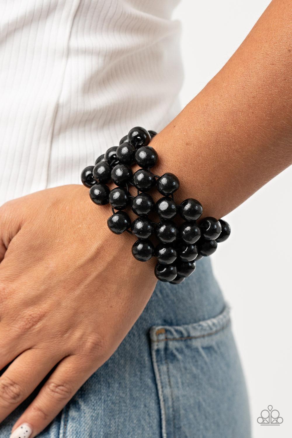 Paparazzi Accessories Tiki Tropicana - Black An oversized collection of black wooden beads are threaded along stretchy bands that ornately weave across the wrist, creating a decorative summery pattern. Sold as one individual bracelet. Jewelry