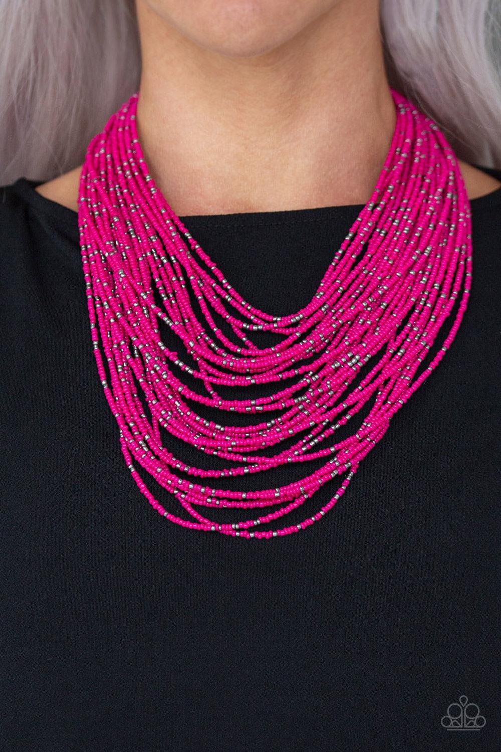Paparazzi Accessories Rio Rainforest - Pink Suspended between two gunmetal fittings, row after row of countless strands of Pink Peacock seed beads layer below the collar. Dainty gunmetal seed beads are sprinkled across the strands for a seasonal finish. F