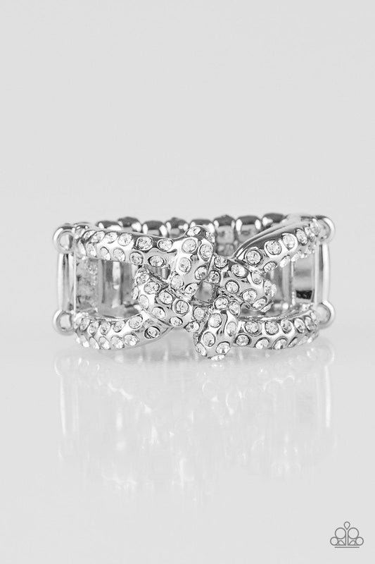 Paparazzi Accessories Can Only Go UPSCALE From Here - White Encrusted in white glittery rhinestones, shimmery silver bars crisscross across the finger, coalescing into a bold square knot atop the finger. Features a stretchy band for a flexible fit. Jewelr