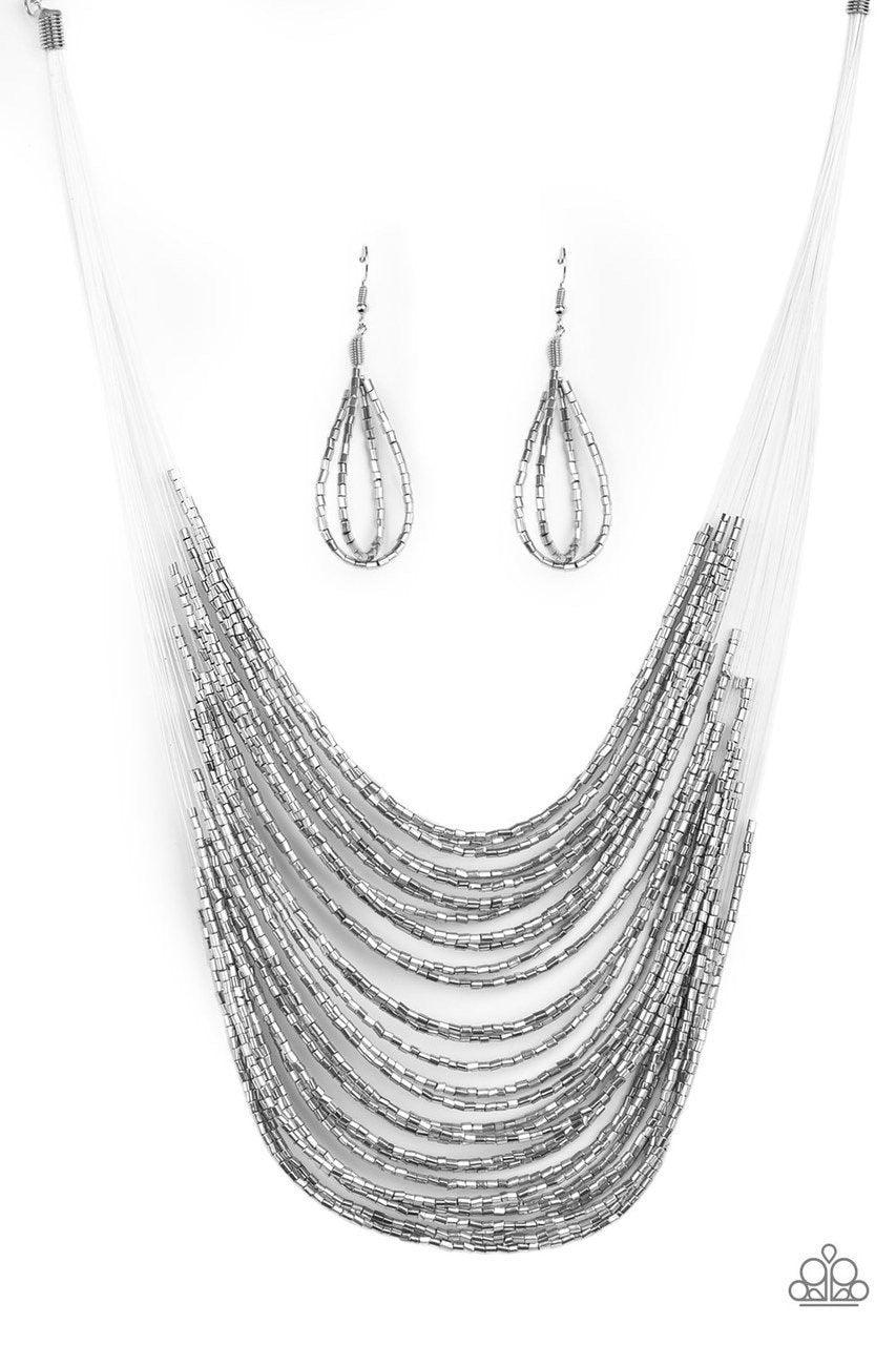 Paparazzi Accessories Catwalk Queen - Silver Strand after strand of metallic silver seed beads fall together to create a bold statement piece. Features an adjustable clasp closure.Sold as one individual necklace. Includes one pair of matching earrings. Je