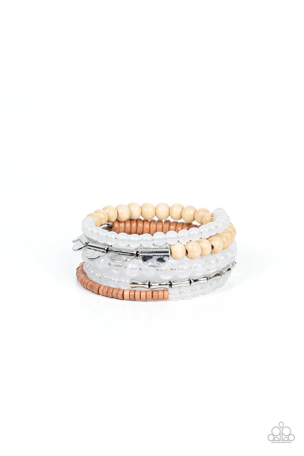 Paparazzi Accessories Free-Spirited Spiral - White Mismatched sections of glassy and opaque white beads join silver discs, brown wooden beads, and brown disc-like beads along a coiled wire, creating an earthy infinity wrap bracelet around the wrist. Sold
