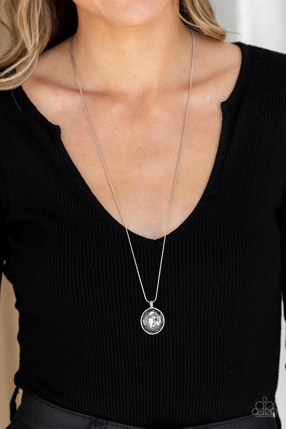 Paparazzi Accessories Instant Icon - Silver An oversized smoky gem is pressed into the center of a sleek silver fitting, creating a mesmerizing statement piece at the bottom of a sleek silver chain. Features an adjustable clasp closure. Sold as one indivi