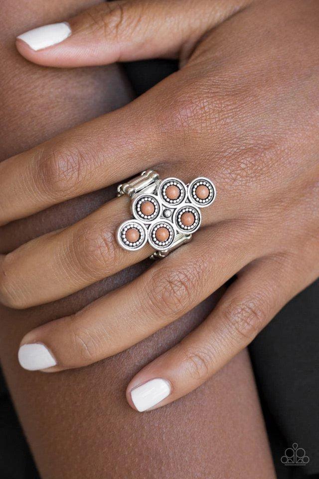 Paparazzi Accessories River Rock Rhythm - Brown Dainty brown stones are pressed into ornate silver frames, coalescing into an earthy frame atop the finger. Features a stretchy band for a flexible fit. Jewelry