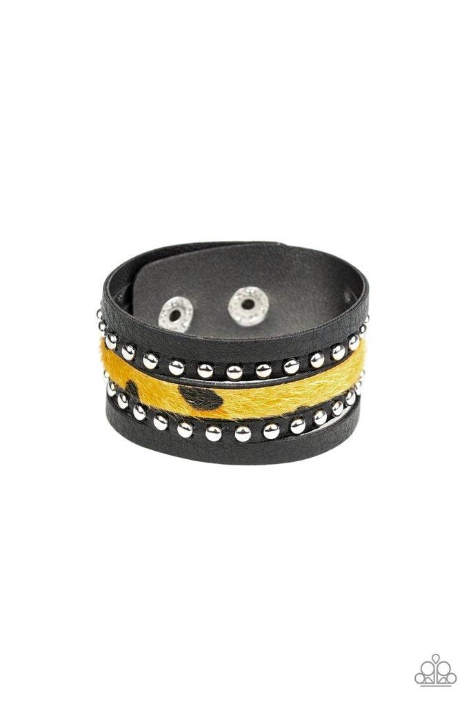 Paparazzi Accessories Born to be Wildcat -Yellow A thick band of black leather has been spliced into layered bands that have been studded and printed in a fuzzy cheetah print for a wild look. Features an adjustable snap closure. Sold as one individual bra